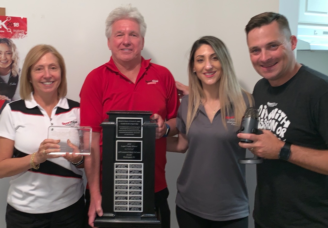 Jeffrey Crummie holding the Logan Trophy, Sherry DeCarme holding the glass name plate, along with Nina Carilli and Chad Jordan